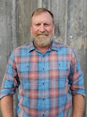 A man with a beard and blue shirt