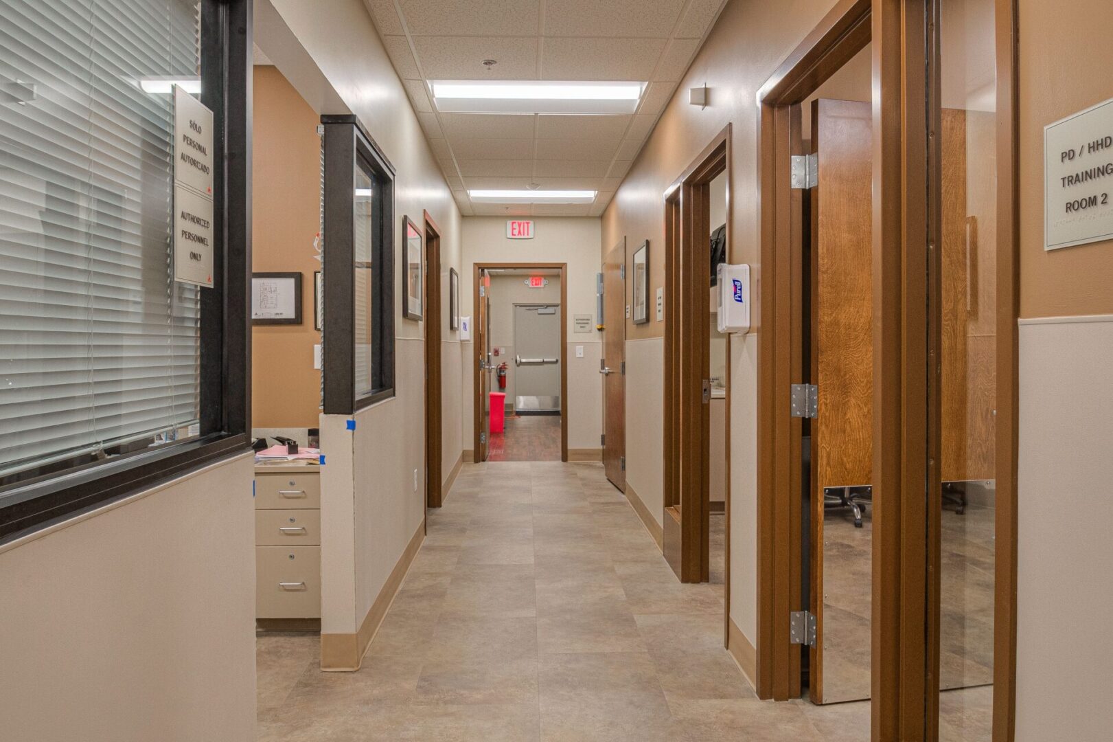 A hallway with many doors and windows in it