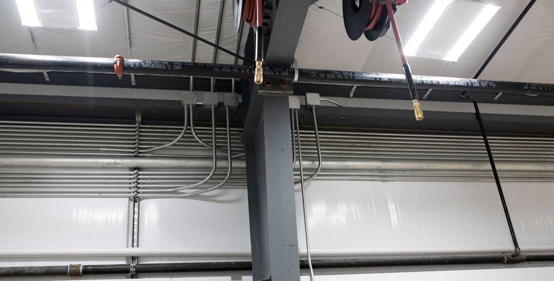 A large metal pole with wires hanging from it.
